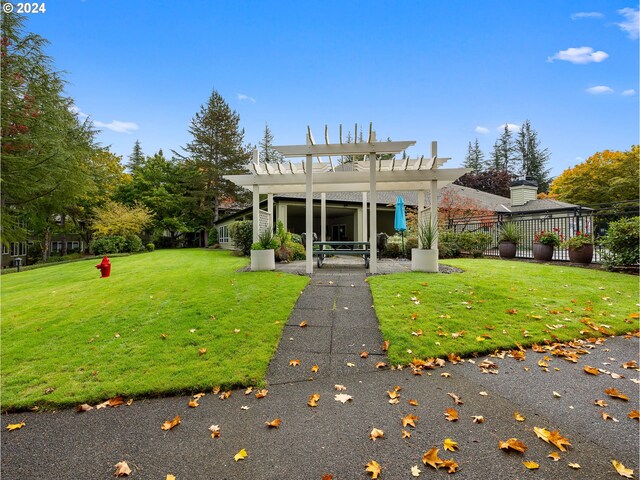 back of house featuring a yard and a pergola