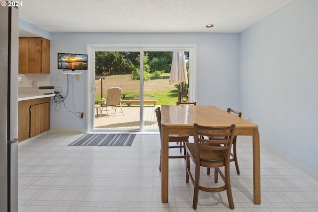 dining room featuring a textured ceiling