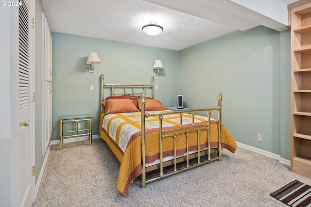 bedroom with a textured ceiling and carpet flooring