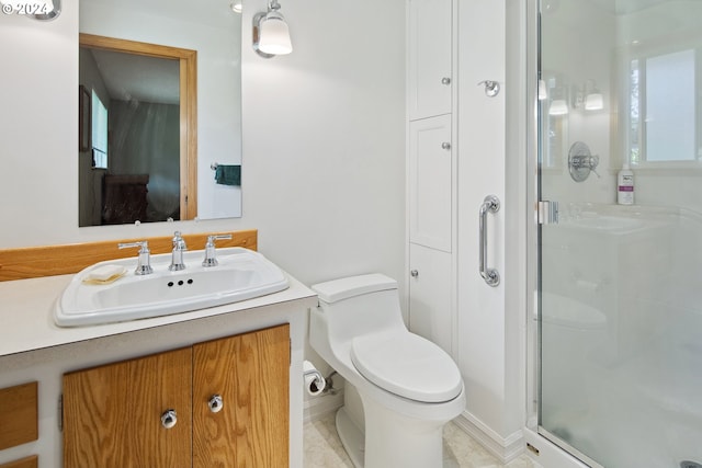 bathroom featuring walk in shower, vanity, toilet, and tile patterned floors