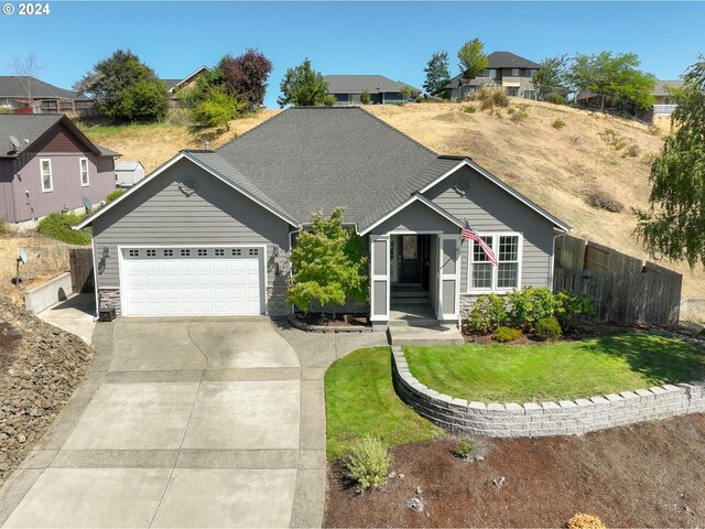 view of front of home with a garage and a front yard