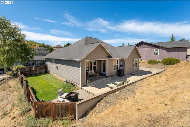 rear view of property featuring a lawn