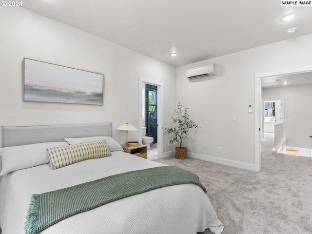 carpeted bedroom featuring a wall mounted air conditioner and ensuite bathroom