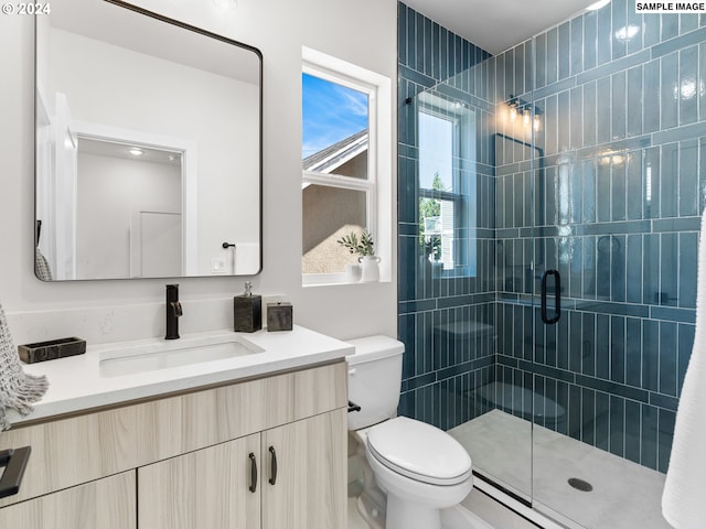 bathroom featuring vanity, an enclosed shower, and toilet