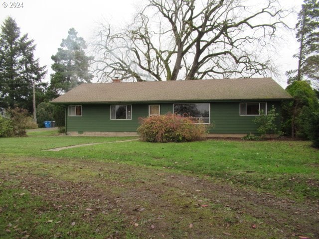 view of side of home with a yard