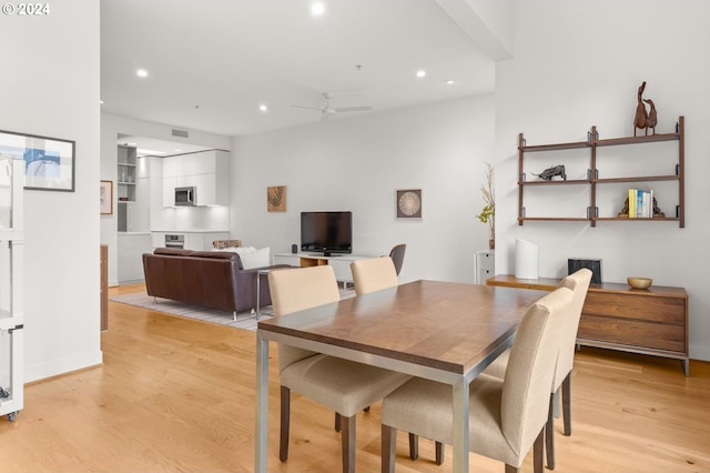 dining room with light hardwood / wood-style floors and ceiling fan