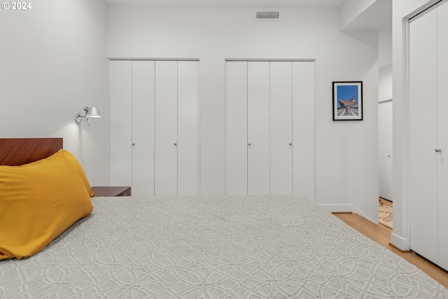 618 NW 12th Ave Unit 409, Portland, OR 97209 - bedroom featuring two closets and wood finished floors