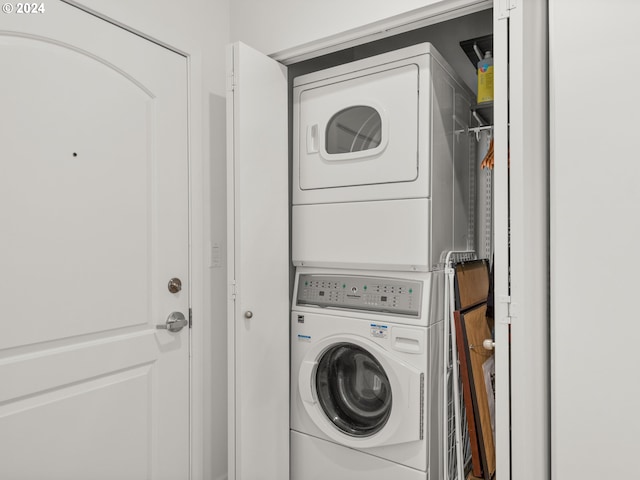 laundry room featuring stacked washer / drying machine