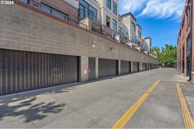 618 NW 12th Ave Unit 409, Portland, OR 97209 - view of asphalt road featuring community garages