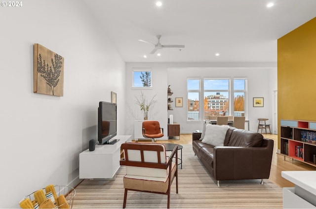 living room featuring light hardwood / wood-style flooring and ceiling fan