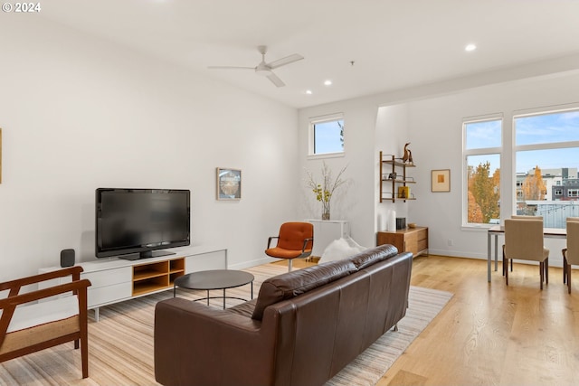 living room featuring ceiling fan, plenty of natural light, and light hardwood / wood-style flooring