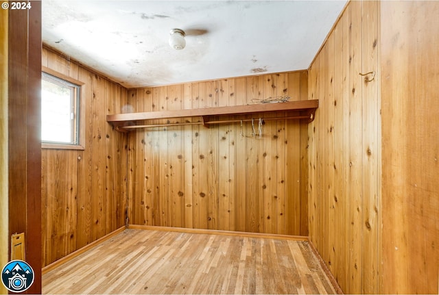 spare room with wood walls and hardwood / wood-style floors