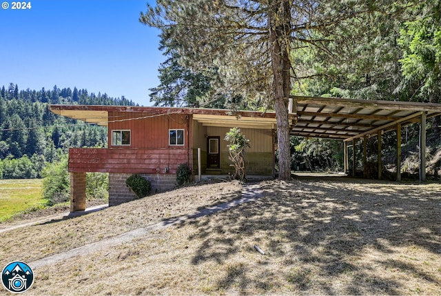 ranch-style home featuring a carport