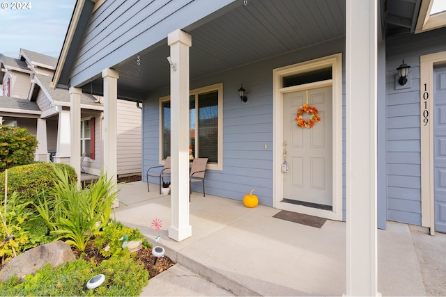 view of exterior entry with covered porch