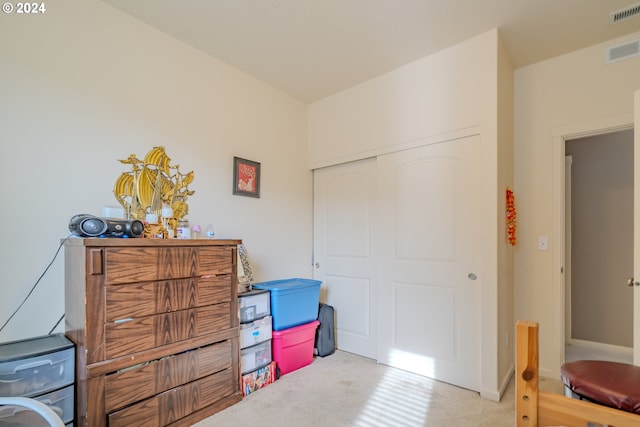 carpeted bedroom with a closet