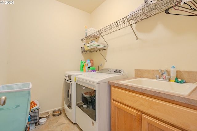 laundry room featuring cabinets, sink, washing machine and dryer, and light tile patterned floors