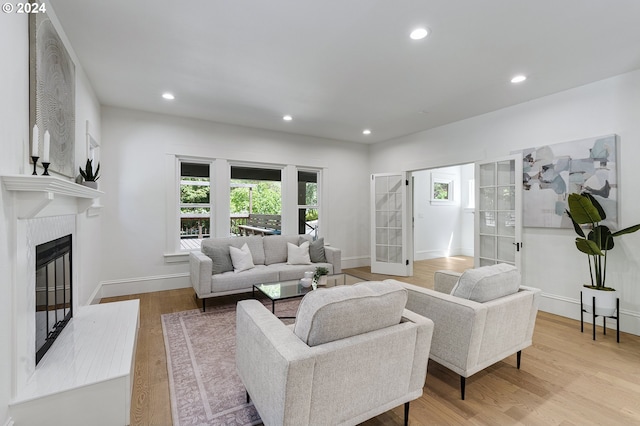 living room with french doors and light hardwood / wood-style floors