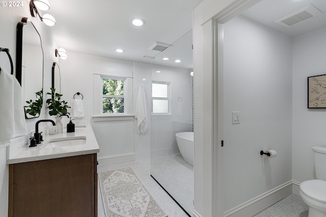 full bathroom featuring vanity, separate shower and tub, and toilet