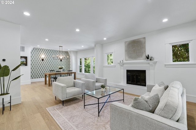 living room featuring light hardwood / wood-style floors and an inviting chandelier