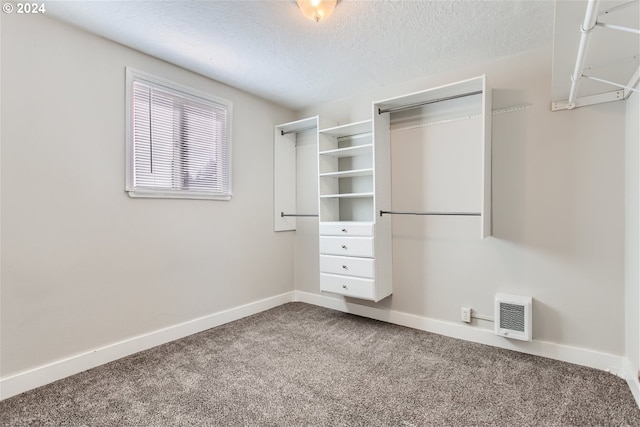 walk in closet with carpet flooring