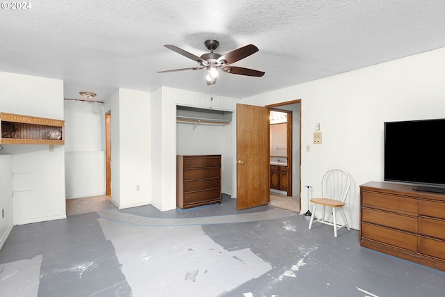 unfurnished bedroom featuring a closet, ceiling fan, and a textured ceiling