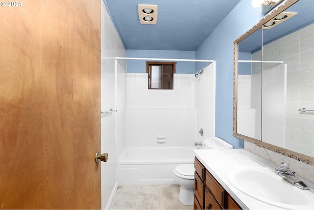 full bathroom featuring a textured ceiling, toilet, tile patterned floors, tiled shower / bath, and vanity