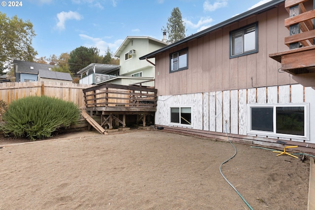 back of house featuring a wooden deck