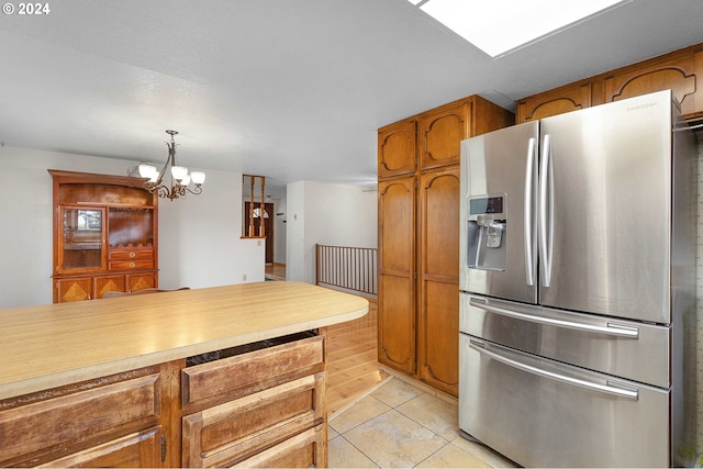 kitchen with a chandelier, stainless steel fridge with ice dispenser, decorative light fixtures, and light tile patterned flooring