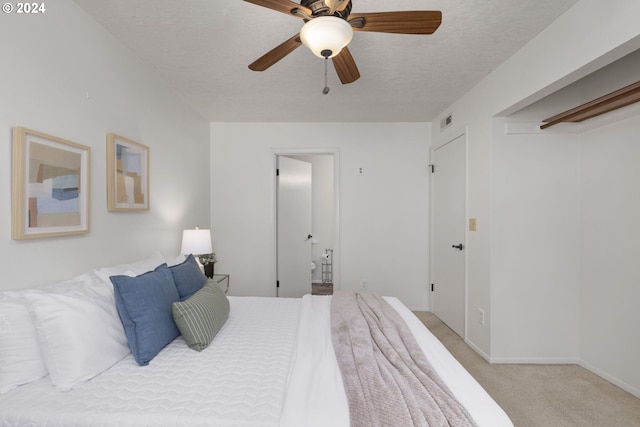 carpeted bedroom with a textured ceiling and ceiling fan