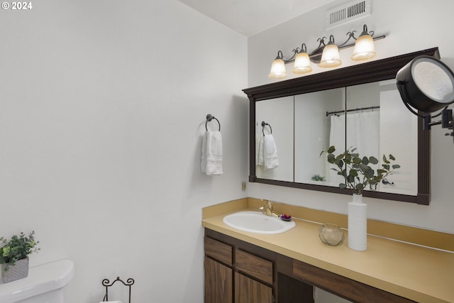 bathroom with vanity and toilet