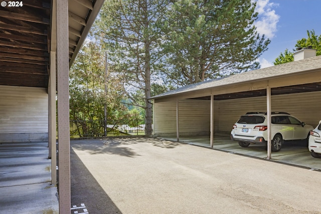 view of vehicle parking with a carport