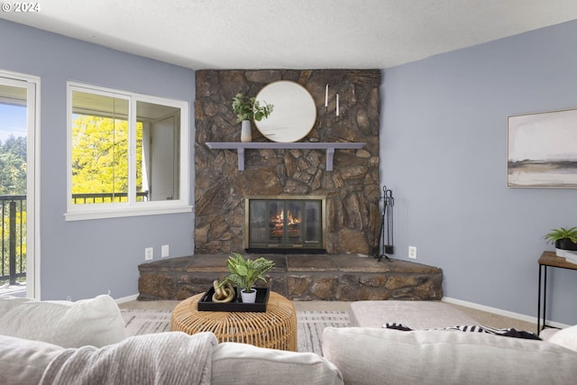 carpeted living room with a fireplace and a textured ceiling