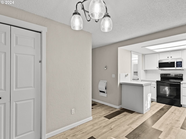 kitchen featuring white cabinetry, black range with electric cooktop, light hardwood / wood-style flooring, pendant lighting, and a textured ceiling