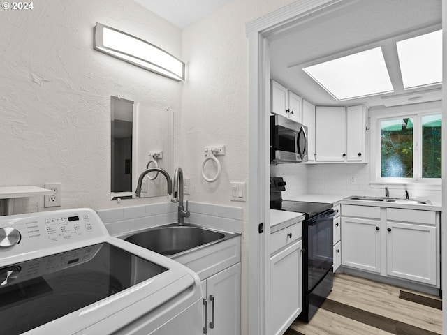 laundry area featuring washer / clothes dryer, sink, and light hardwood / wood-style floors