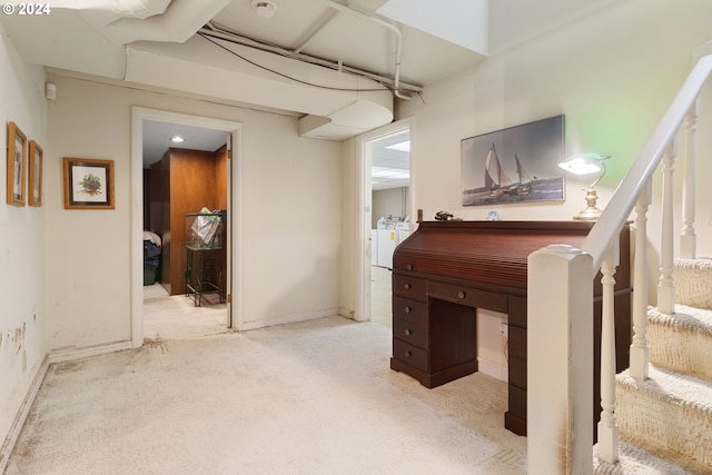 miscellaneous room featuring light carpet and washing machine and clothes dryer