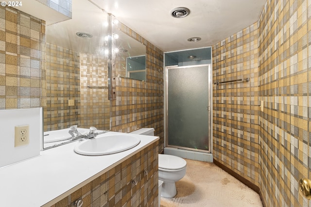 bathroom featuring toilet, an enclosed shower, and vanity