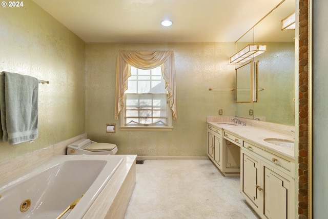 bathroom featuring vanity, a relaxing tiled tub, and toilet