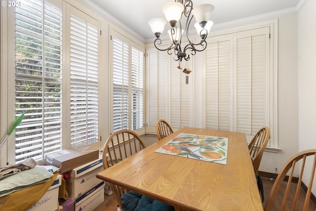 dining room with crown molding, a healthy amount of sunlight, and a notable chandelier