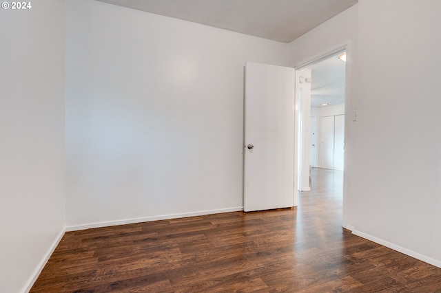 empty room featuring dark hardwood / wood-style flooring