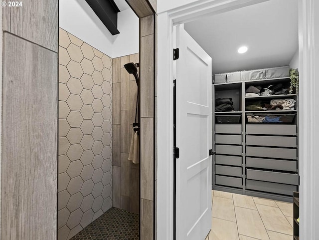 bathroom with tile patterned floors and a tile shower