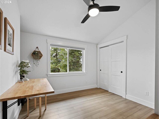 interior space with vaulted ceiling, ceiling fan, and light hardwood / wood-style flooring