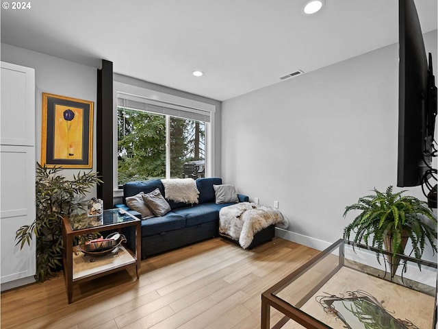 living room with recessed lighting, wood finished floors, visible vents, and baseboards