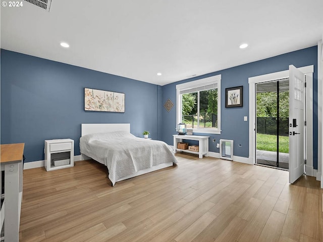 bedroom featuring access to exterior, recessed lighting, light wood-type flooring, and baseboards
