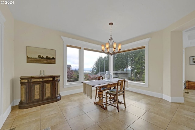 dining area with light tile patterned floors and a chandelier