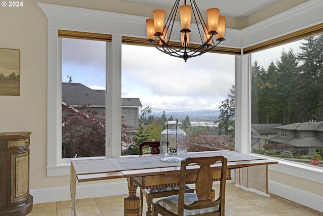 tiled dining area with a healthy amount of sunlight and a chandelier