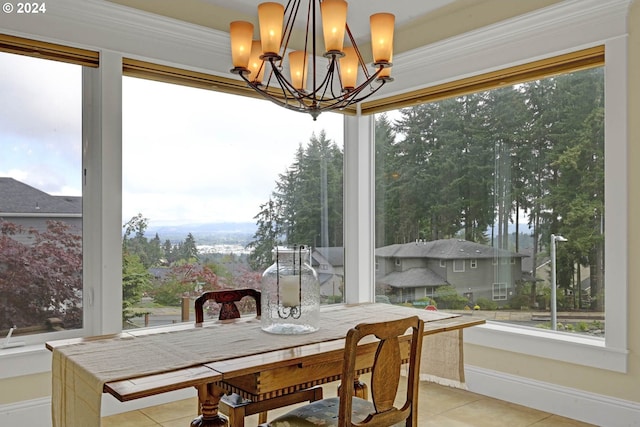 dining area featuring an inviting chandelier and light tile patterned floors