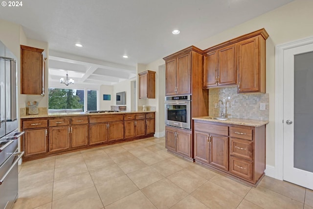 kitchen with backsplash, beamed ceiling, stainless steel appliances, an inviting chandelier, and sink