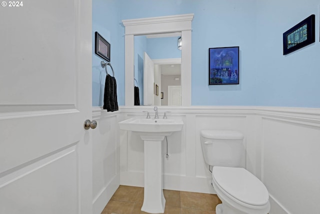 bathroom featuring tile patterned flooring and toilet