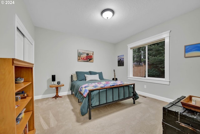 bedroom with a textured ceiling and carpet flooring