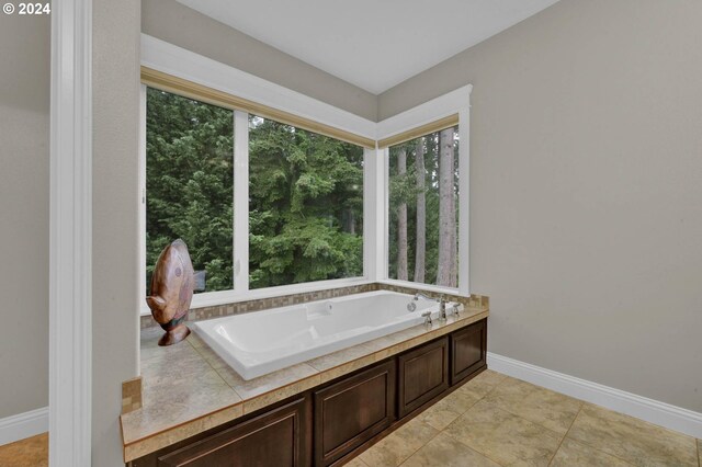 bathroom with tile patterned floors and a tub